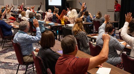 People raising their hands during training