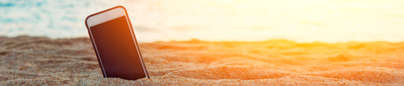 Cell Phone in the sand at sunset